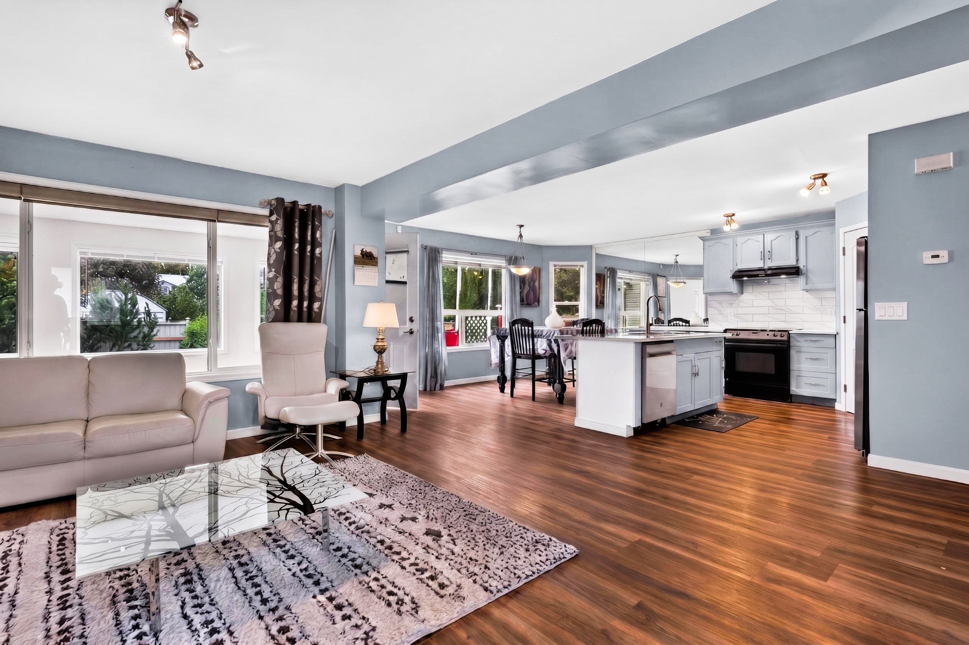 Open-concept view from living room through to dining area and kitchen
